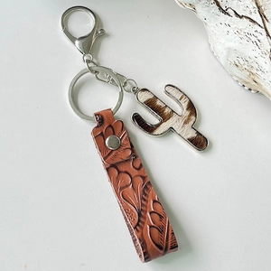 Western style brown embossed leather cactus keychain with cowhide texture and silver buckle