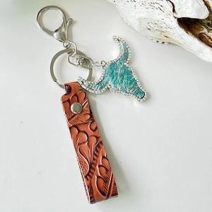 Vintage western leather keychain with embossed pattern and rhinestone bull head charm