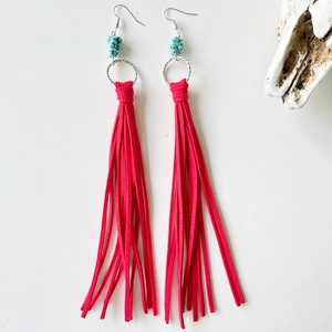 Western boho earrings with red suede tassels and turquoise beads on white background