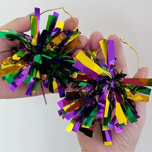 Detail showing oversized rainbow laser fringe earrings on gold hoop held by hand