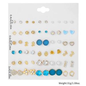 Macro detail of 30 pairs earring set showing pearls crystals and geometric metal studs
