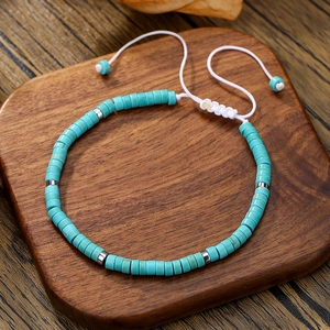 Detail of bohemian turquoise beaded bracelet on a rustic wooden display board