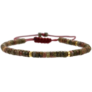 Detail of bohemian unakite stone bracelet with red woven cord and adjustable slide knot