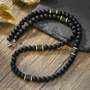 Men's volcanic lava stone beaded necklace with matte black beads and gold metal spacers