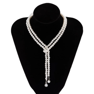 Detail of layered pearl necklace with Y-shape drop and sparkling crystal teardrop pendant