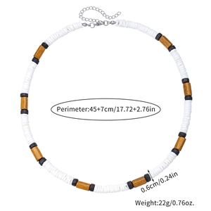Detail of beaded necklace showing white shell discs, wood beads, and lobster clasp closure