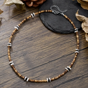 Detail of bohemian wood and coconut shell necklace with silver lobster clasp and adjuster