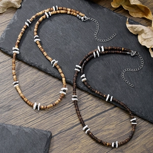 Men's bohemian shell and wood bead necklace with stainless steel clasp on a rustic background