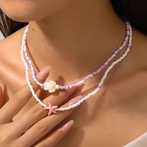 Bohemian multilayer seed bead necklace with white turtle and pink starfish charms