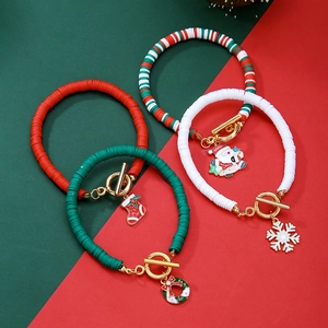 Close-up of Christmas Heishi bead bracelets with Santa and snowflake charms