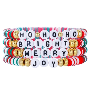 Detail of four Christmas beaded bracelets with festive red green and white clay discs