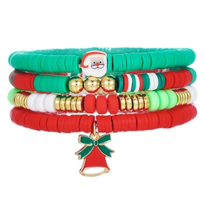 Detail of Christmas bracelet set featuring red green heishi beads and Santa charms