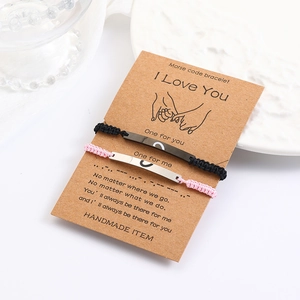Detail of Morse code braided couple bracelets with heart engraving on paper card