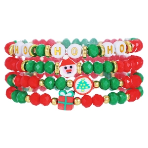 Close-up of Christmas charm bracelets with Santa Claus and HO HO HO letter charms