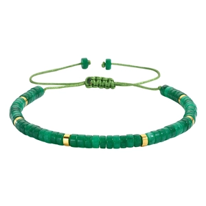Adjustable woven bracelet with green cylinder stones and golden beads on white background