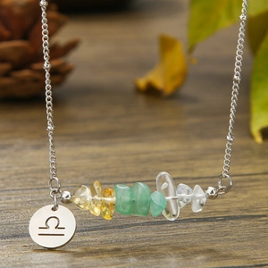 Detail of Libra zodiac pendant with natural tumbled stones on a silver-tone chain necklace