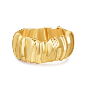 Macro detail of golden wave textured cuff bracelet with polished interior and glossy finish