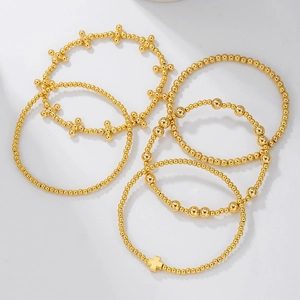 Set of 6 gold beaded stretch bracelets for women with a polished cross charm