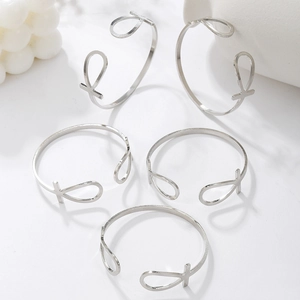Detailed view of silver Ankh cross bracelets with adjustable C-shape and teardrop charms
