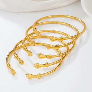 Set of five gold punk fist open bangles featuring minimalist hip-hop stacking design