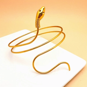 Detail of a vintage golden snake arm cuff with a three-layer spiral textured design