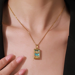 Detail of gold-plated stainless steel Tarot The Sun pendant necklace with crystals