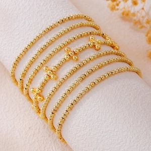 7-piece bohemian stackable gold beaded bracelet set featuring unique cross charms