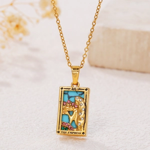 Macro detail of The Empress tarot pendant with green enamel and colorful zircon stones