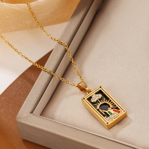 Detail of The Magician tarot card pendant with black enamel and zircons on gold chain