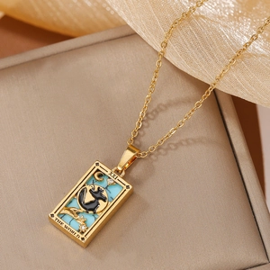 Detailed view of The World tarot pendant with blue enamel and a black cat pattern