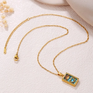 Detail of gold stainless steel necklace with blue Empress tarot card enamel pendant