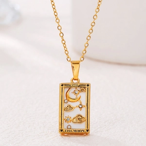 Macro detail of golden tarot Moon pendant with Roman numeral XVIII and white zircons