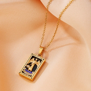 Detail of gold Temperance tarot pendant with embossed angel and blue zircon on silk