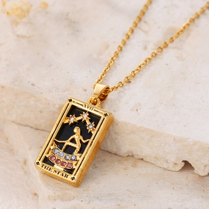 Macro detail of golden The Star tarot card pendant with colorful zircons and O-chain