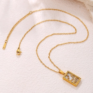Detailed macro view of The Moon tarot pendant in gold finish with sparkling zircons