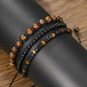 Three-piece tiger eye and black agate beaded bracelet set for men on display stand