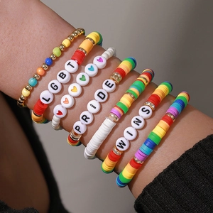 Rainbow LGBT Pride beaded bracelet set with gold accents and heart charms on model