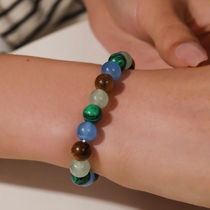 Close-up of mixed color beaded bracelet featuring tiger eye and malachite stones