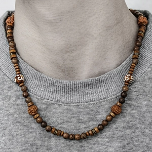 Close-up of Bohemian wood beads and textured seed charms on a vintage beach necklace