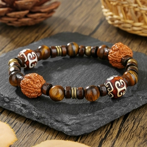 Handmade retro beaded bracelet with tiger eye stone and dZi bead on dark stone plate
