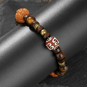 Retro handmade beaded bracelet with tiger eye stones and walnut dZi beads on a display stand