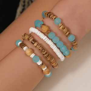 Detail of 5-piece bohemian beaded bracelets set featuring wood, resin, and shell beads