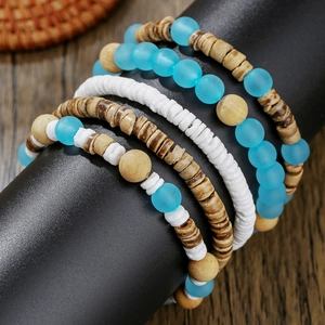 Bohemian multi-layer beaded bracelet with wood, shell, and blue beads for beach vacation style