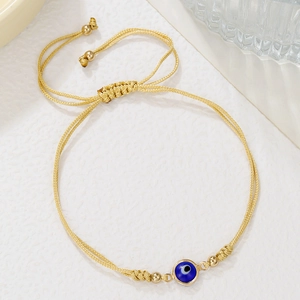 Verstelbare goudgeweven Evil Eye armband met blauwe kraal en metalen accenten