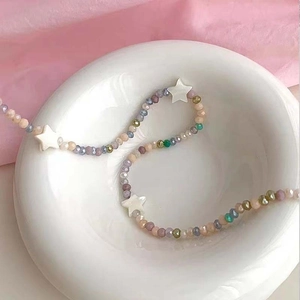 Morandi colored beaded star necklace with multifaceted beads and white star pendants
