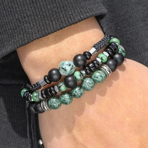 Detailed shot of beaded bracelets with green stone, matte black beads and silver metal spacers