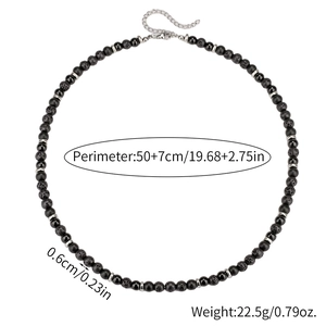 Detail of beaded necklace showing lava rock texture, black beads, and lobster clasp closure