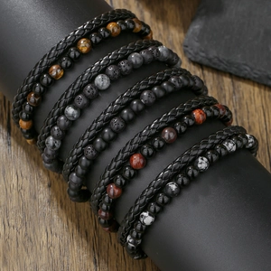 Detalle de pulseras multicapa para hombre de cuero trenzado con ojo de tigre y cuentas de ónix