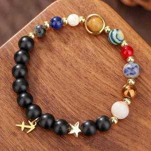 Solar system natural stone beaded bracelet with Sagittarius star charm on wood base
