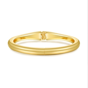 Polished gold chunky irregular spring bangle bracelet with minimalist metal finish